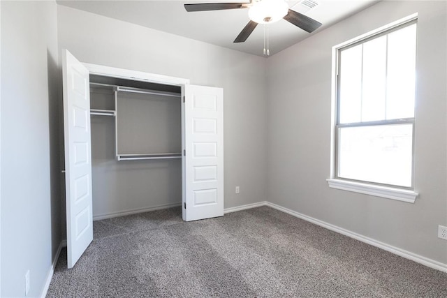 unfurnished bedroom with a closet, carpet flooring, baseboards, and a ceiling fan