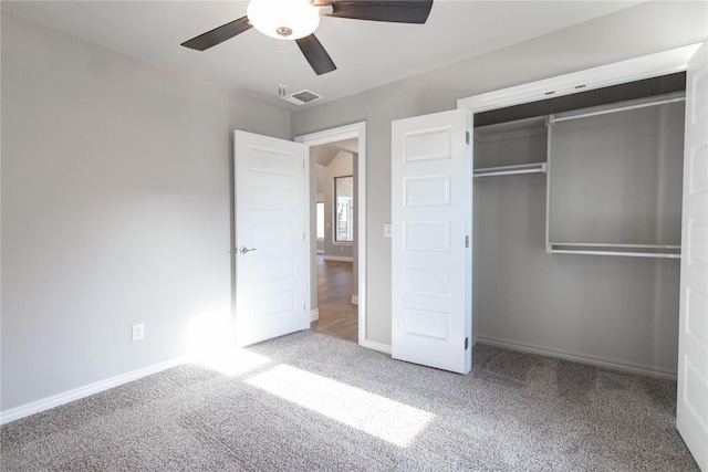 unfurnished bedroom featuring a closet, carpet floors, visible vents, and baseboards