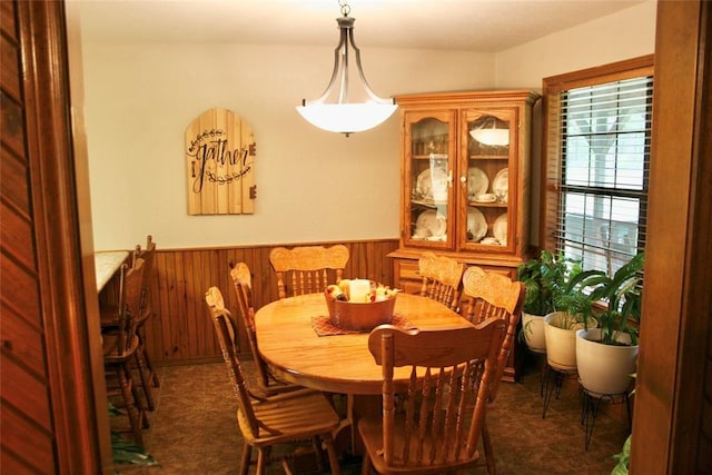 dining area featuring wooden walls