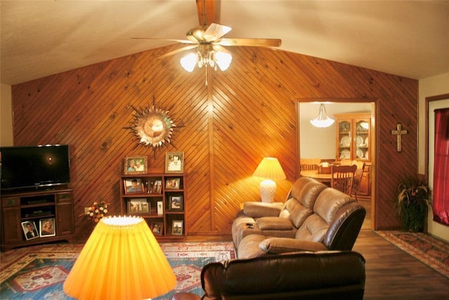 living room with wood walls, dark hardwood / wood-style flooring, and high vaulted ceiling