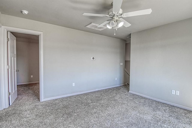 carpeted spare room with ceiling fan