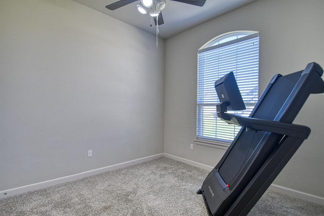 workout room featuring light carpet and ceiling fan