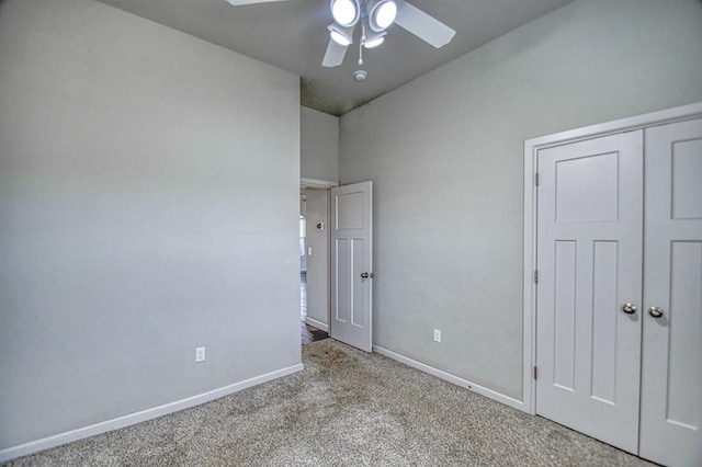 unfurnished bedroom featuring ceiling fan, light colored carpet, and a closet