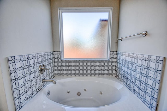 bathroom featuring a bathtub and a wealth of natural light