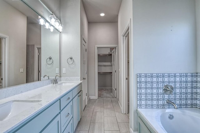 bathroom featuring vanity and a tub to relax in