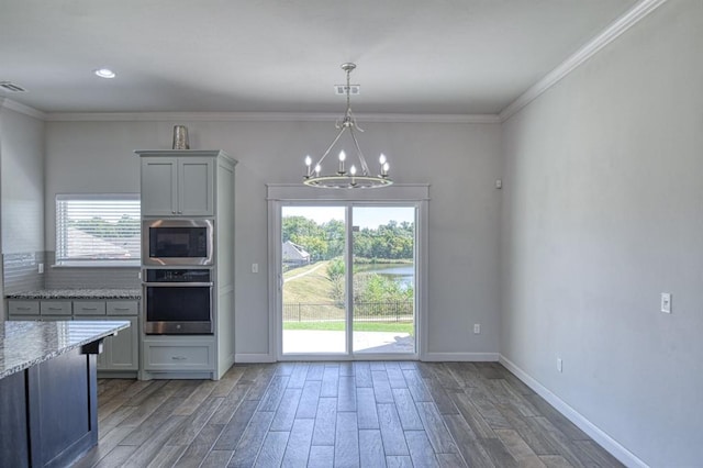 kitchen with dark wood-type flooring, a healthy amount of sunlight, and appliances with stainless steel finishes