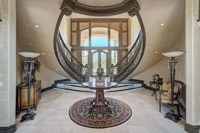 entrance foyer with french doors and a towering ceiling