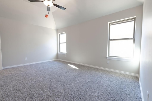 carpeted spare room with ceiling fan and lofted ceiling