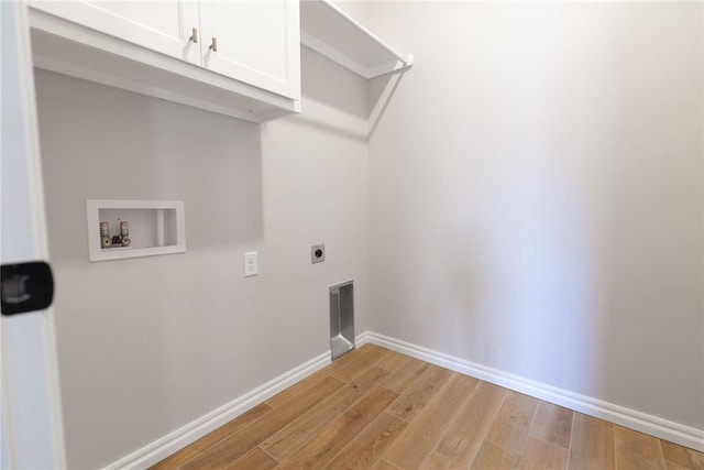 laundry area featuring cabinets, washer hookup, light hardwood / wood-style flooring, and hookup for an electric dryer