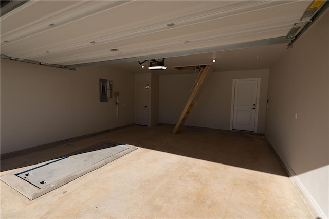 garage featuring electric panel and a garage door opener