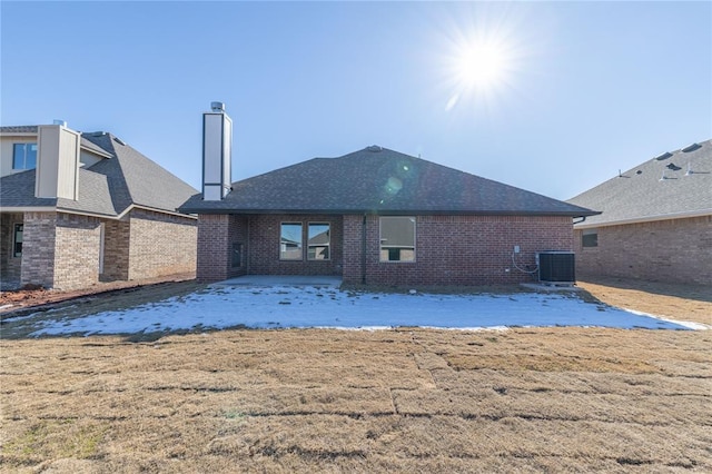 back of house featuring a lawn, a patio area, and central AC unit