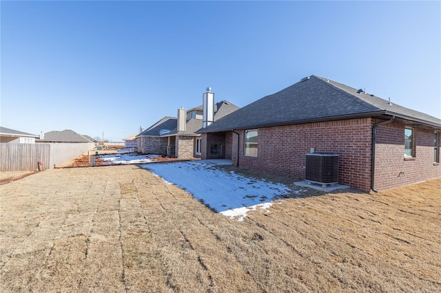 rear view of property featuring central AC unit and a patio area