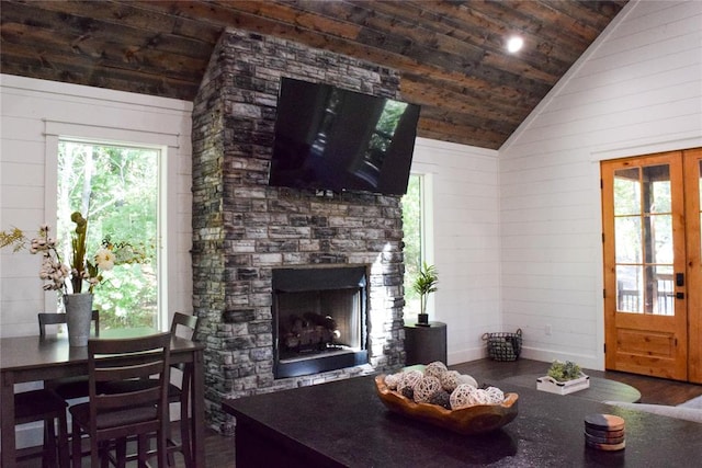 living room featuring wood ceiling, a fireplace, plenty of natural light, and dark wood-type flooring