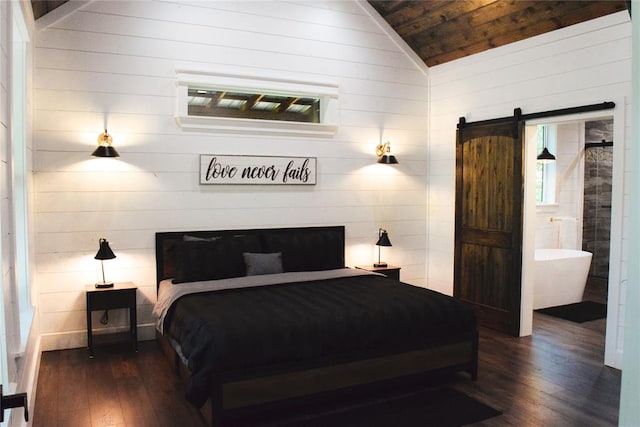 bedroom with lofted ceiling, wooden walls, dark hardwood / wood-style floors, a barn door, and wood ceiling