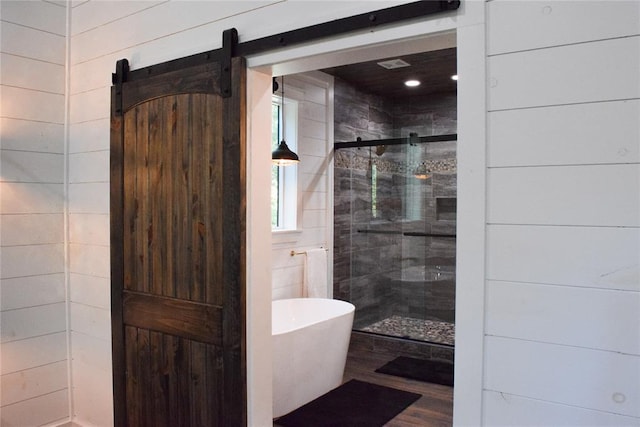 bathroom featuring hardwood / wood-style floors and shower with separate bathtub