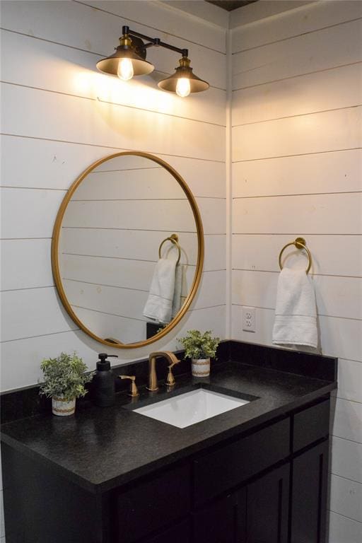 bathroom with wooden walls and vanity