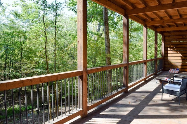 unfurnished sunroom featuring a healthy amount of sunlight and wood ceiling