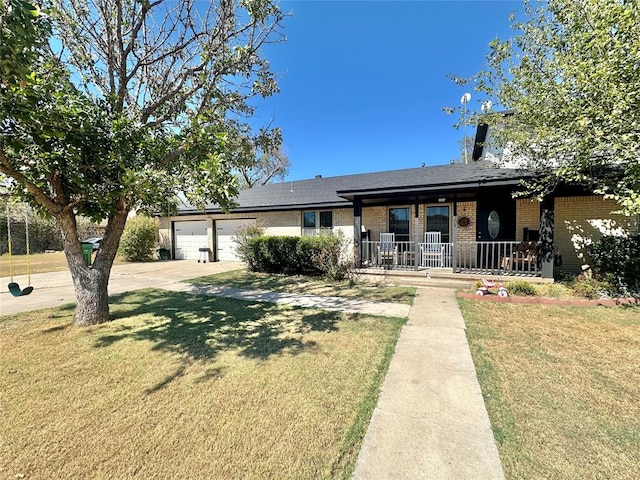 view of front facade featuring covered porch, a garage, and a front lawn