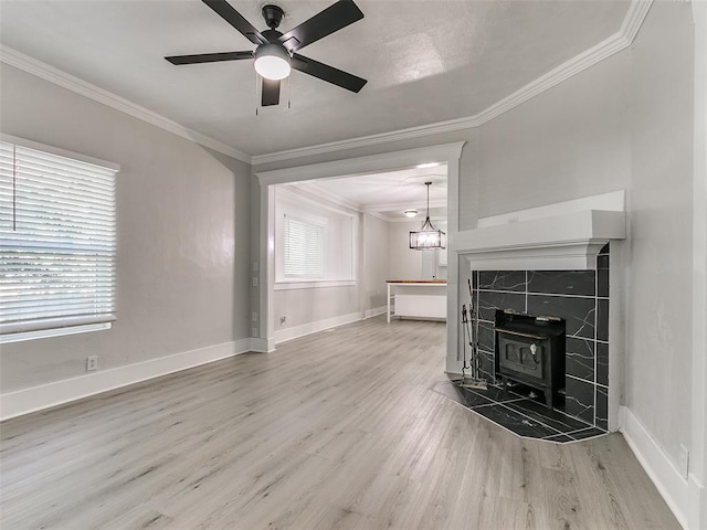 unfurnished living room featuring hardwood / wood-style floors, a healthy amount of sunlight, and a wood stove