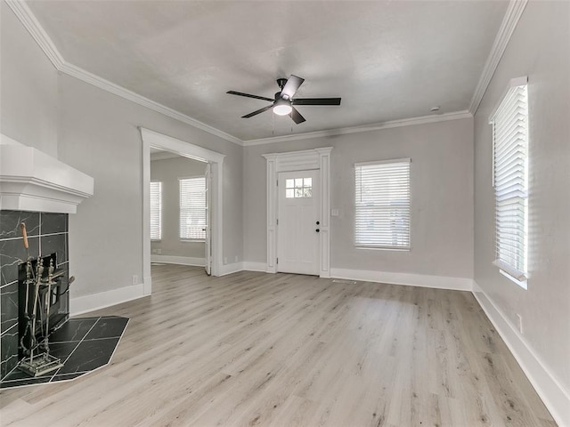 entryway featuring light hardwood / wood-style floors, a wealth of natural light, and a tiled fireplace