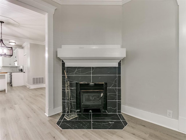 details with a wood stove, wood-type flooring, and ornamental molding