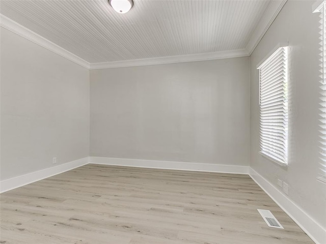 empty room with ornamental molding and light hardwood / wood-style flooring