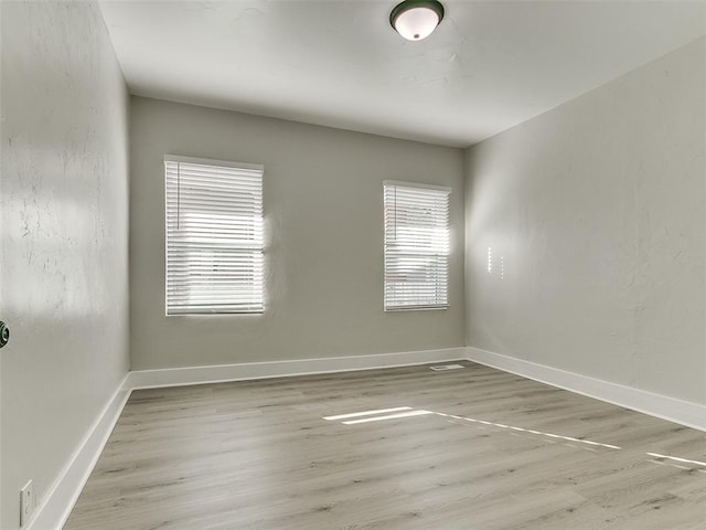 spare room with light hardwood / wood-style flooring