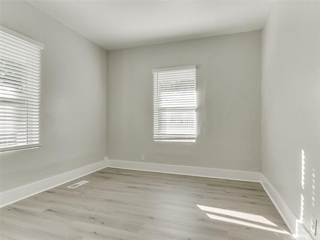 spare room featuring light hardwood / wood-style floors