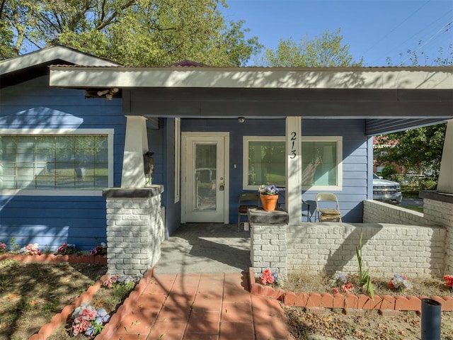 doorway to property with a porch