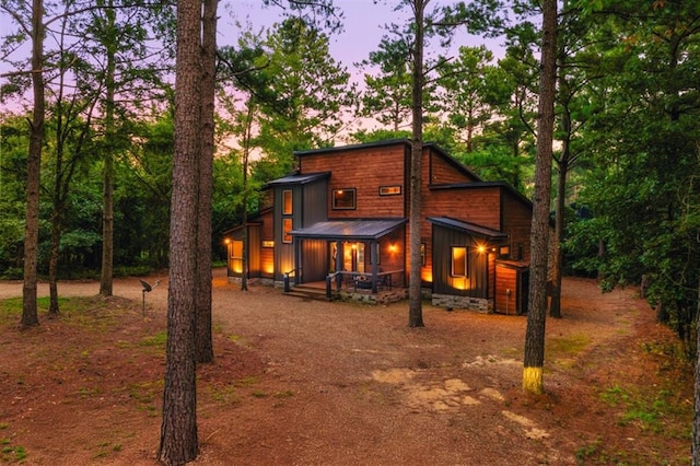 view of back house at dusk