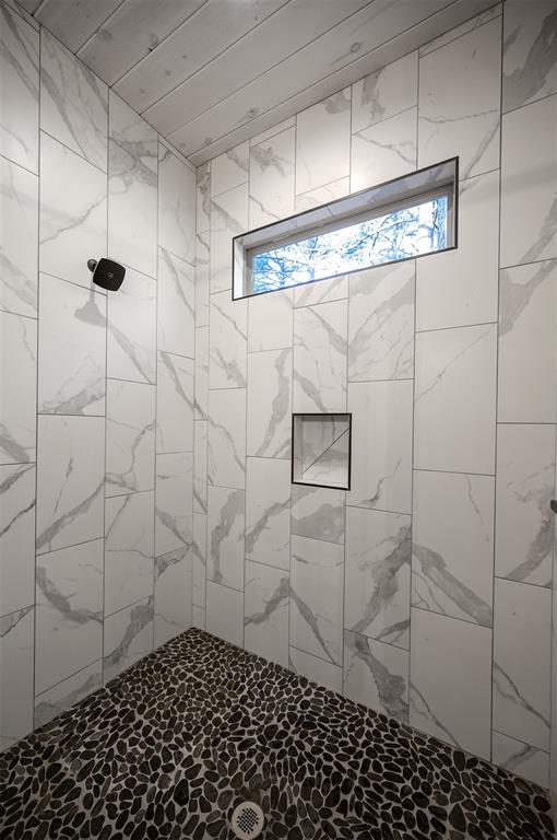 bathroom with a tile shower