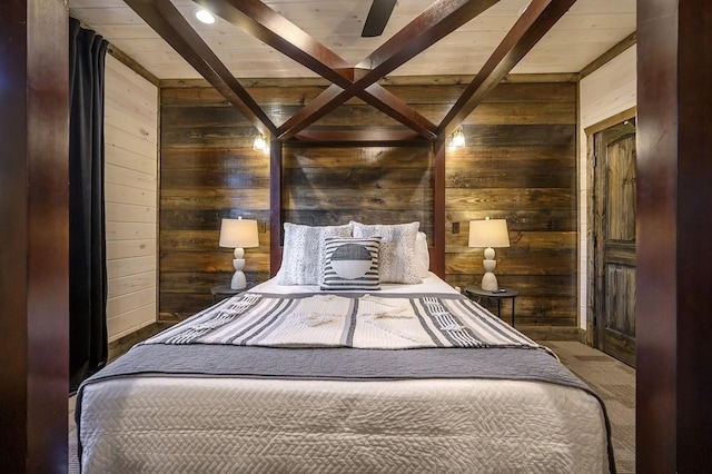 bedroom with beamed ceiling, ceiling fan, and wooden walls