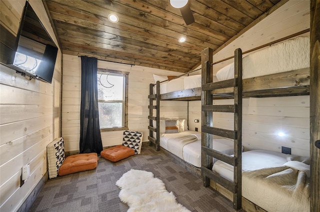 bedroom with dark carpet, lofted ceiling, wooden ceiling, wooden walls, and ceiling fan