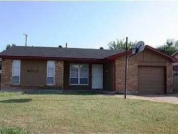 4012 SE 47th St, Oklahoma City, OK 73135 - ranch-style home with an attached garage, a front yard, brick siding, and driveway
