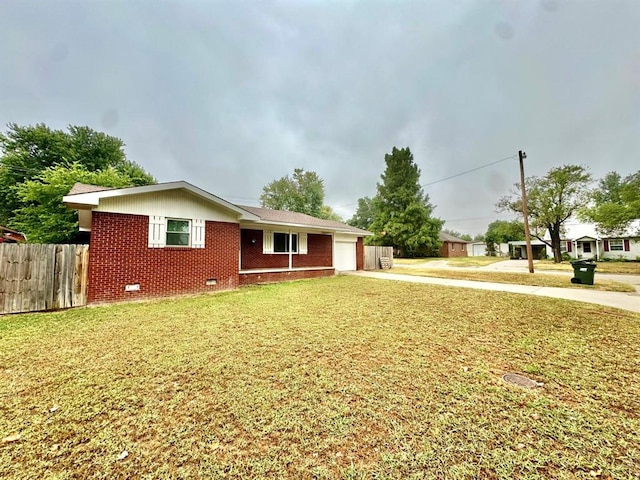 ranch-style house with a garage and a front lawn