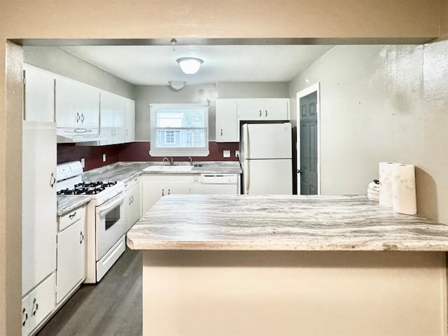 kitchen with white cabinets, dark hardwood / wood-style flooring, white appliances, and sink