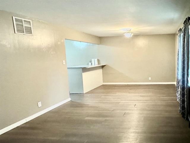 spare room featuring wood-type flooring