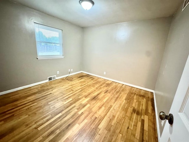 unfurnished room featuring hardwood / wood-style flooring