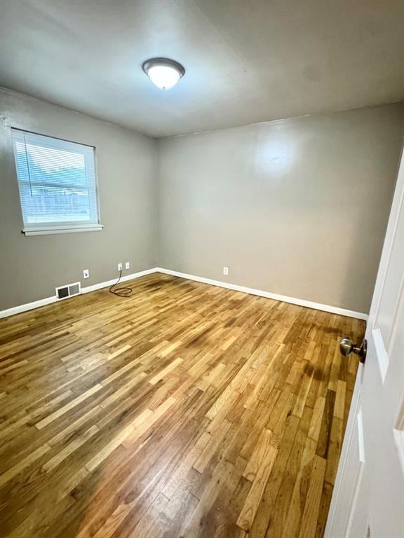 unfurnished room featuring hardwood / wood-style floors