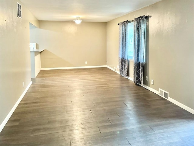 spare room featuring wood-type flooring