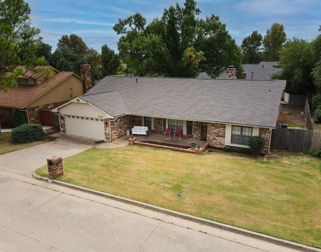 single story home featuring a front lawn and a garage