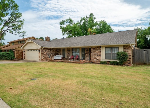 ranch-style home featuring a porch, a garage, and a front lawn