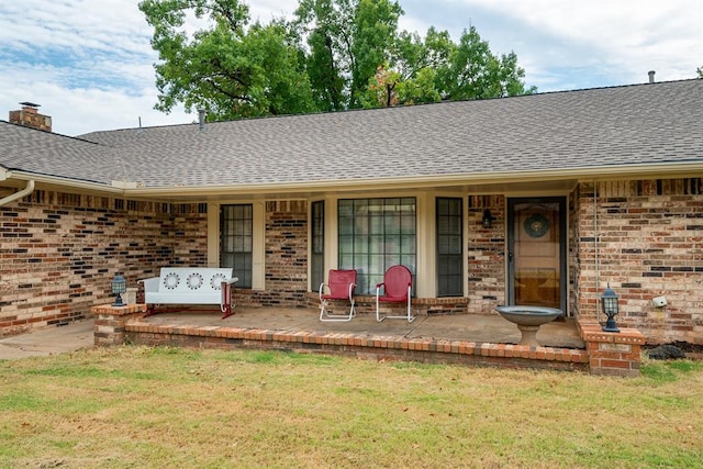 doorway to property with a lawn