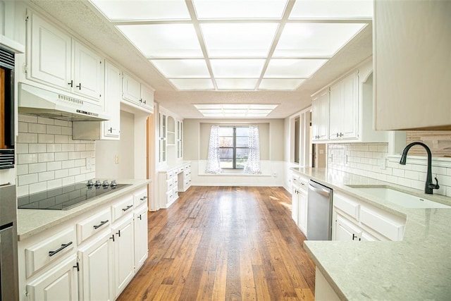 kitchen with dishwasher, black electric cooktop, white cabinets, and sink