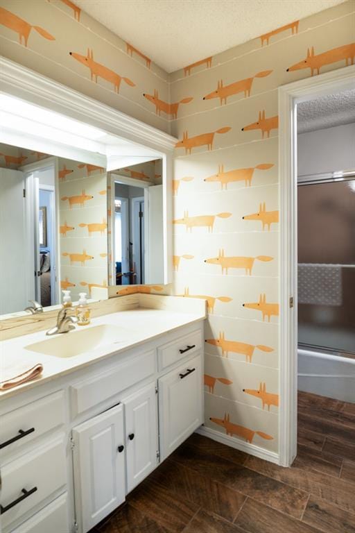 bathroom featuring vanity, wood-type flooring, and an enclosed shower