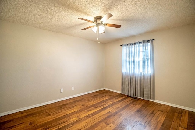 unfurnished room featuring dark hardwood / wood-style floors, ceiling fan, and a textured ceiling