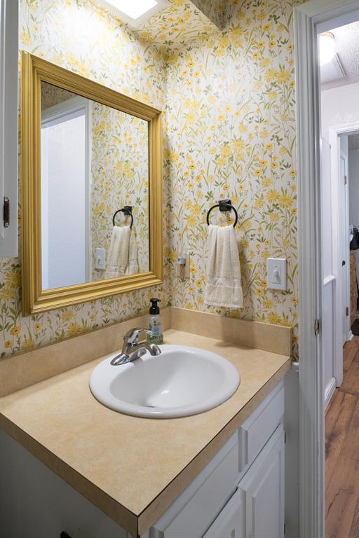 bathroom with vanity and hardwood / wood-style flooring