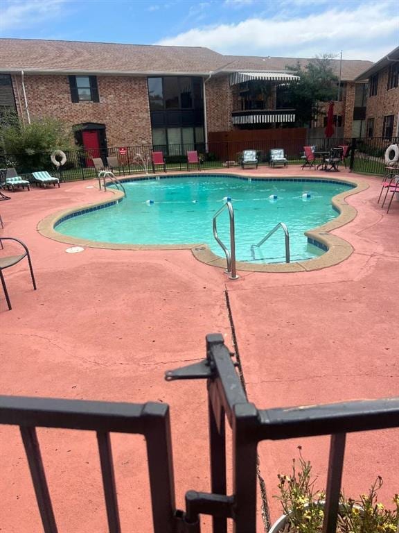 view of swimming pool with a patio