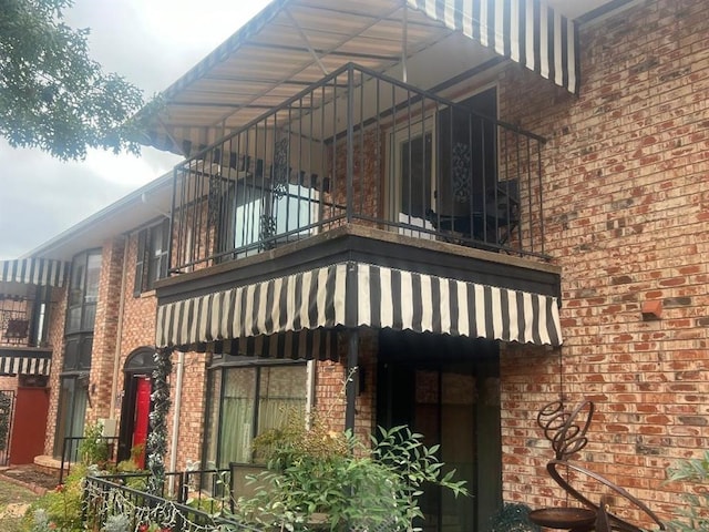 view of side of home featuring a balcony