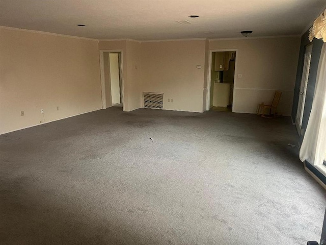 empty room with crown molding and carpet floors